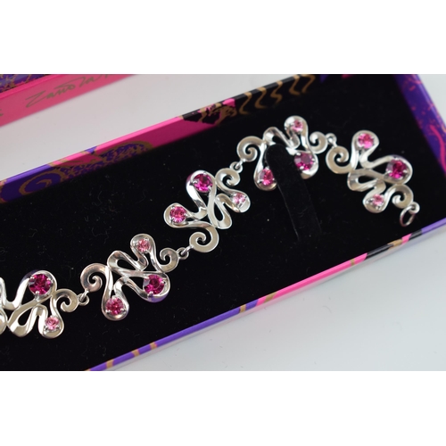 382 - Boxed Zandra Rhodes silver bracelet of scrolled links, set pink paste, 24.8 grams, 20cm long.