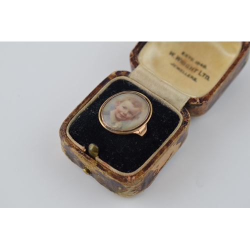 383 - A Georgian or later yellow metal (tests as 9ct gold - rose) mourning ring with a miniature under gla... 