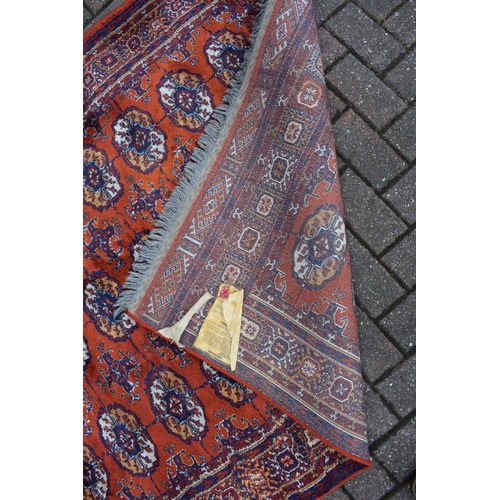 74 - Bokhara carpet in cashmere and silk. Traditional elephants foot pattern with stylised floral boarder... 