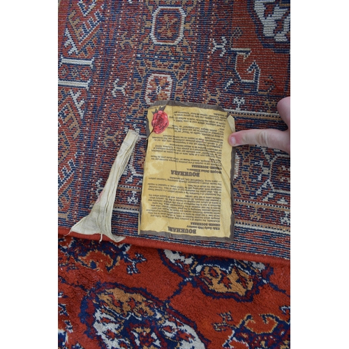 74 - Bokhara carpet in cashmere and silk. Traditional elephants foot pattern with stylised floral boarder... 