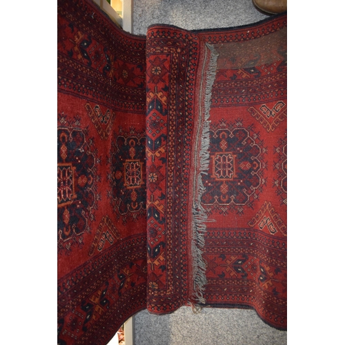 76 - A oriental / middle-eastern runner carpet / rug in deep reds, blues, oranges and cream. 83cm x 390cm... 