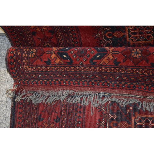 76 - A oriental / middle-eastern runner carpet / rug in deep reds, blues, oranges and cream. 83cm x 390cm... 