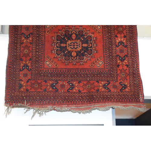 76 - A oriental / middle-eastern runner carpet / rug in deep reds, blues, oranges and cream. 83cm x 390cm... 