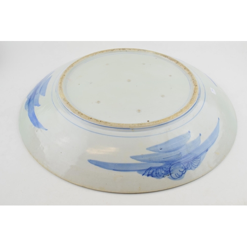 213 - Late 19th century large Japanese charger with foliage design, blue tones, 46cm wide (restored).