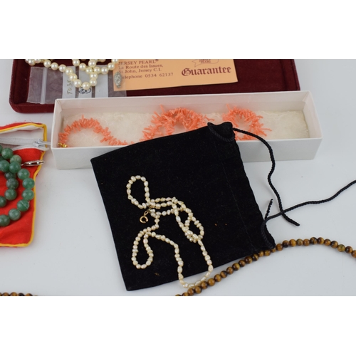 187 - A collection of jewellery items to include freshwater pearls, Jersey pearls, coral necklace, jade ne... 