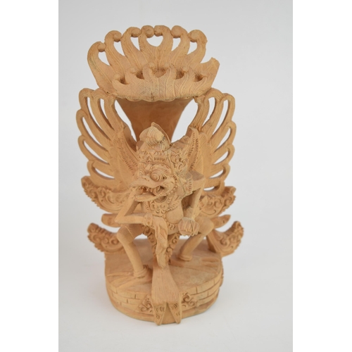 215 - Three carvings of deities from Bali. In different woods. (3) Height 25cm.