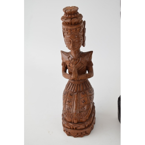 215 - Three carvings of deities from Bali. In different woods. (3) Height 25cm.