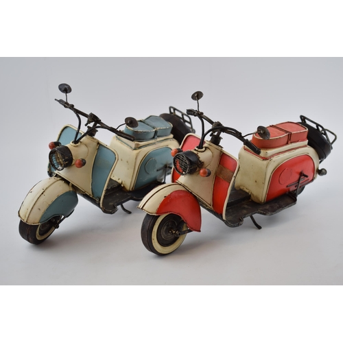 296 - A pair of vintage style models of 2 lambrettas, one in blue and the other in red, 41cm long (2).