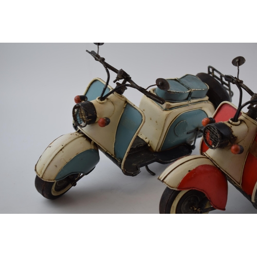 296 - A pair of vintage style models of 2 lambrettas, one in blue and the other in red, 41cm long (2).