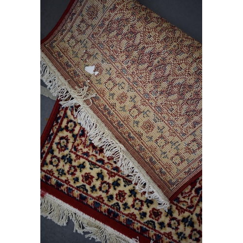 183 - A Persian style hearth rug in red blues and creams. 59cm x 108cm.
