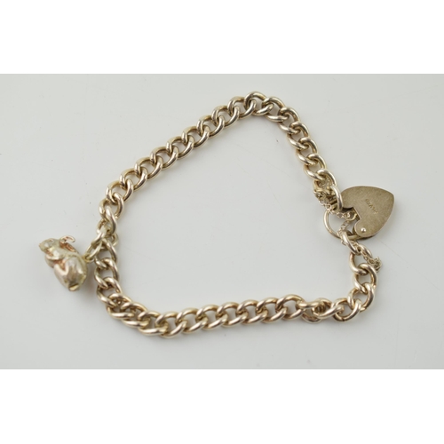 190 - A silver bracelet with heart shaped clasp and rabbit charm, 20.0 grams.