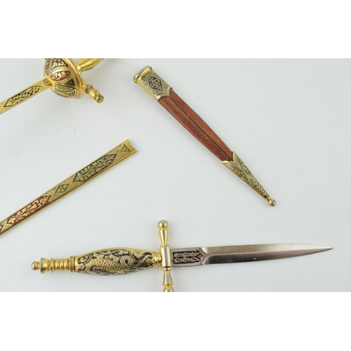 203 - A pair of novelty letter openers in the form of swords and daggers, 22cm longest (2).