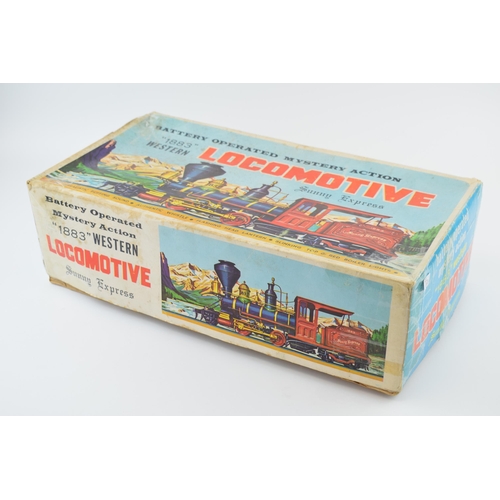 264 - A boxed vintage Locomotive '1883' Sunny Express battery operated toy train. Length 40cm.