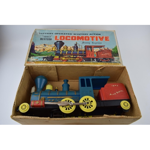 264 - A boxed vintage Locomotive '1883' Sunny Express battery operated toy train. Length 40cm.