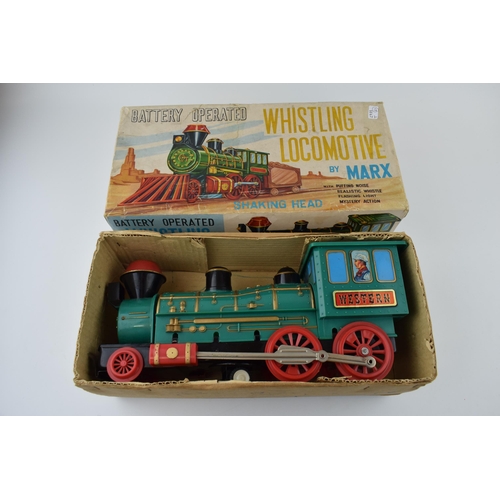 265 - A boxed vintage Whistling Locomotive by Marx, battery operated toy train. Length 33cm.