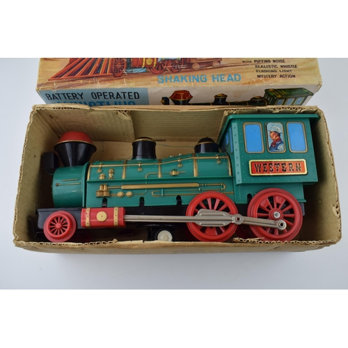 265 - A boxed vintage Whistling Locomotive by Marx, battery operated toy train. Length 33cm.