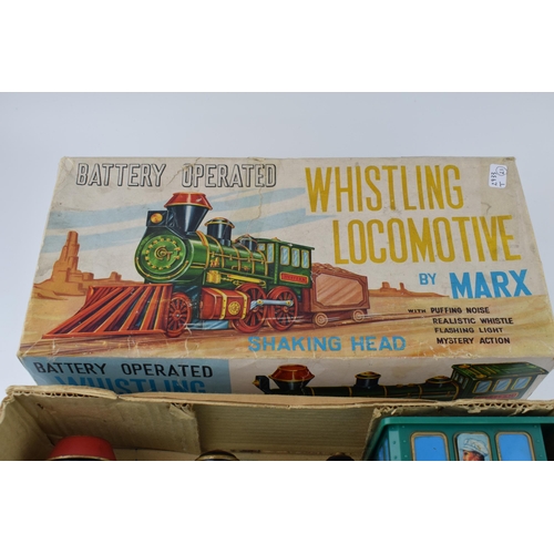 265 - A boxed vintage Whistling Locomotive by Marx, battery operated toy train. Length 33cm.