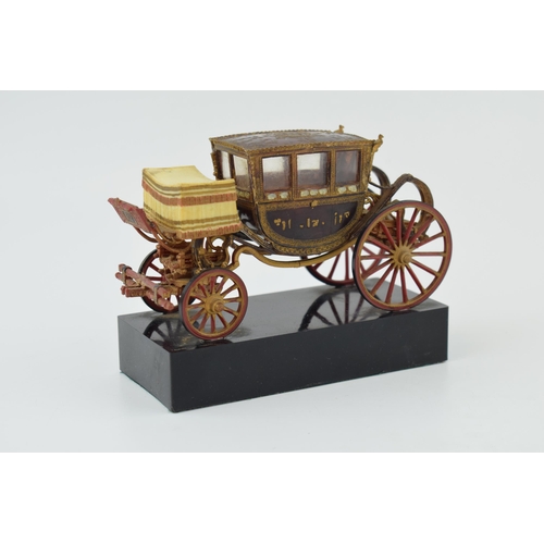 266 - Vintage model of a stage coach on plinth, in early plastic. Mae in Spain. Height 10cm.