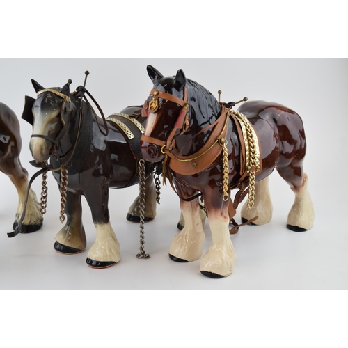 28 - A trio of large pottery shire horses in leather harnesses for working, largest 35cm long (3), collec... 
