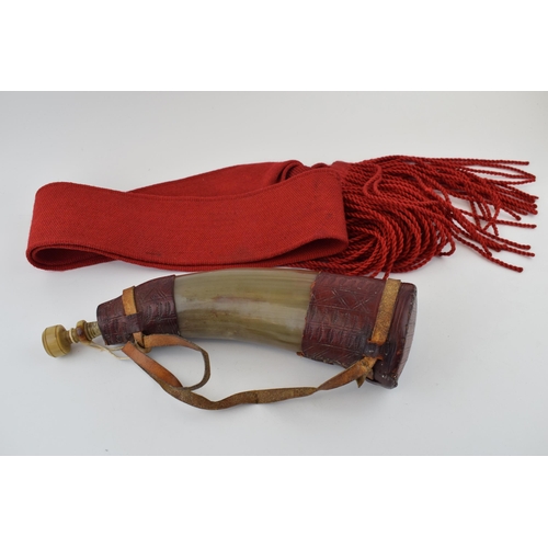 282 - A horn powder flask with red leather decoration. Original stopper present,  Length 32cm,  together w... 