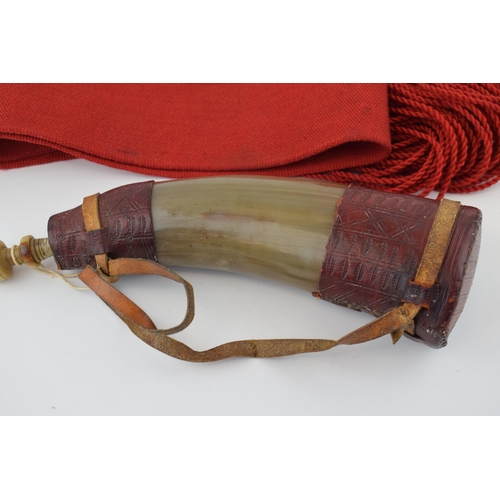 282 - A horn powder flask with red leather decoration. Original stopper present,  Length 32cm,  together w... 