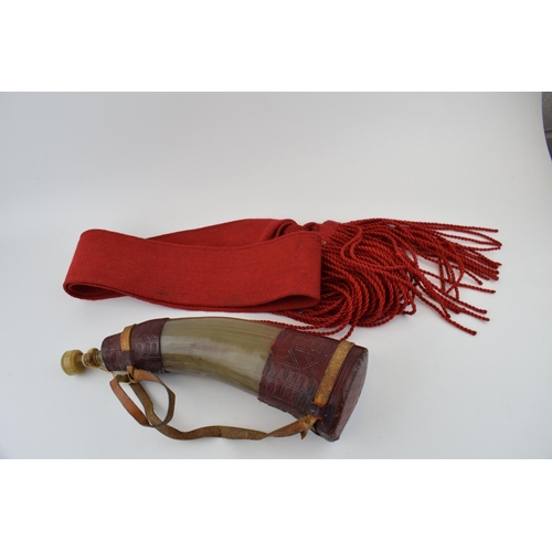 282 - A horn powder flask with red leather decoration. Original stopper present,  Length 32cm,  together w... 