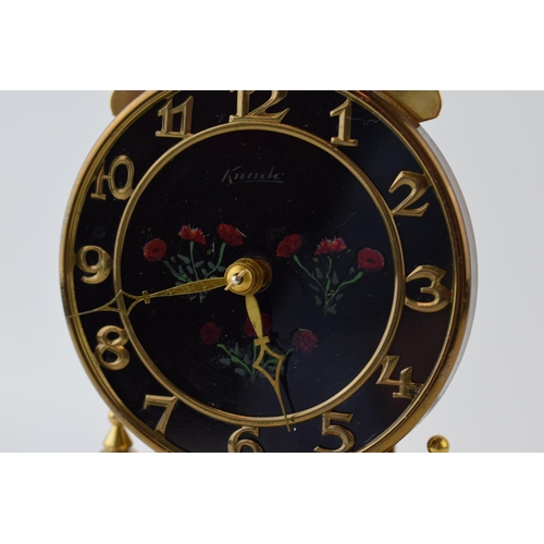 290 - An Anniversary clock by Kundo, Made in West Germany, brass base with hand-painted floral decoration ... 