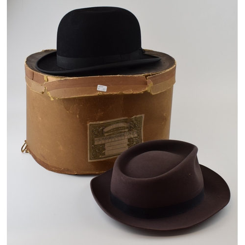 295 - Two vintage hats to include a Bowler hat by Tyrers Ltd and a Fedora in an original hat box by Woolis... 