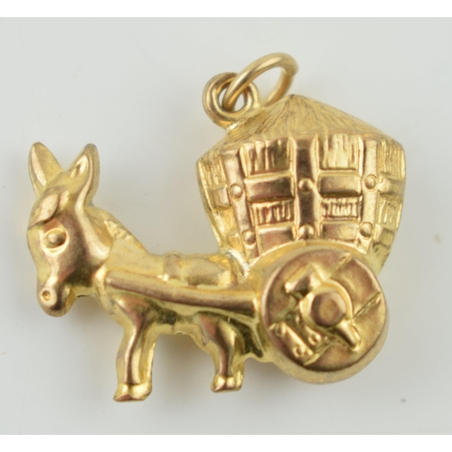 306 - 9ct gold charm in the form of a donkey pulling a cart, 1.3 grams.