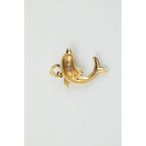 307 - 9ct gold pendant in the form of a dolphin, illusion set diamonds, 1.4 grams, 25mm long.