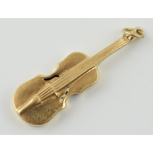 308 - 9ct gold charm in the form of a cello, 0.8 grams.