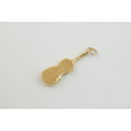 308 - 9ct gold charm in the form of a cello, 0.8 grams.