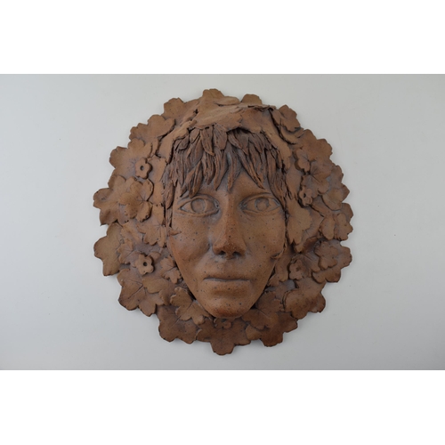 42 - A studio pottery 'Green Man' style pottery wall plaque marked 'Masquerade to the reverse. Height 33c... 