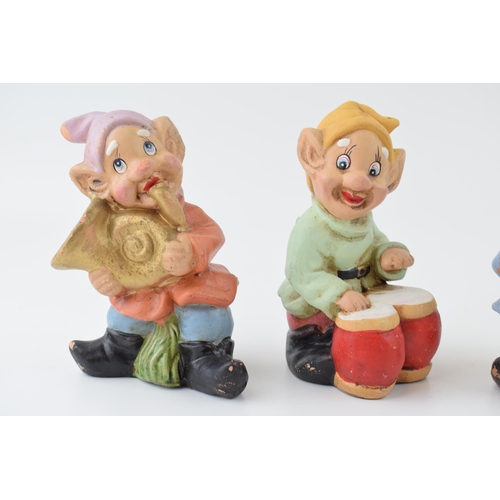 45 - A trio of vintage terracotta gnomes playing musical instruments. Height 14cm.