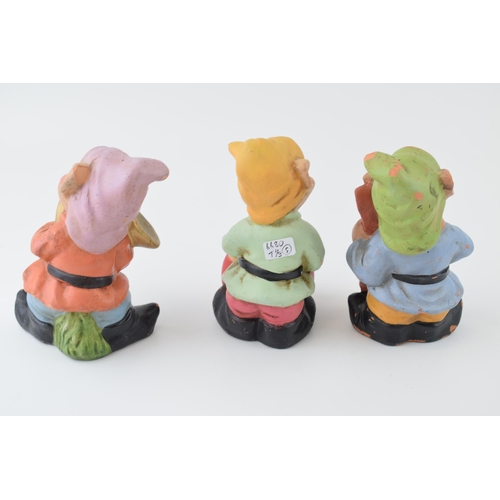 45 - A trio of vintage terracotta gnomes playing musical instruments. Height 14cm.