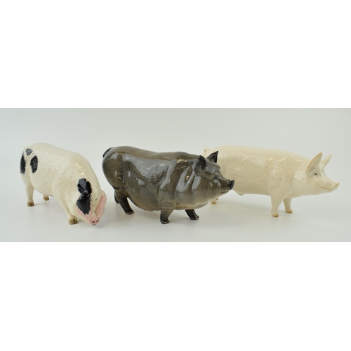 130 - A trio of Royal Doulton pigs to include the Vietnamese Pot Bellied pig, a White Boar and a Glouceste... 