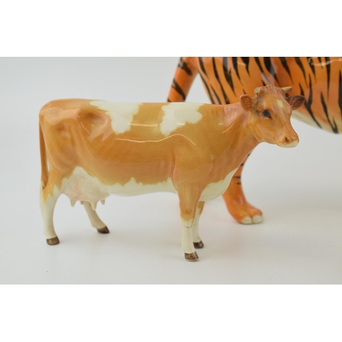 145 - Damaged Beswick animals to include a tiger, a Guernsey cow and a kingfisher (3 - all damaged).