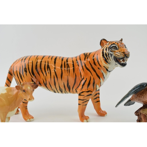 145 - Damaged Beswick animals to include a tiger, a Guernsey cow and a kingfisher (3 - all damaged).