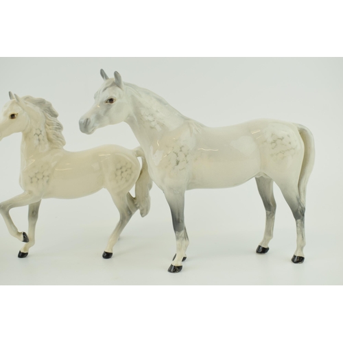 146 - Beswick grey horses to include a prancing arab, an arab bahram and one other (3).