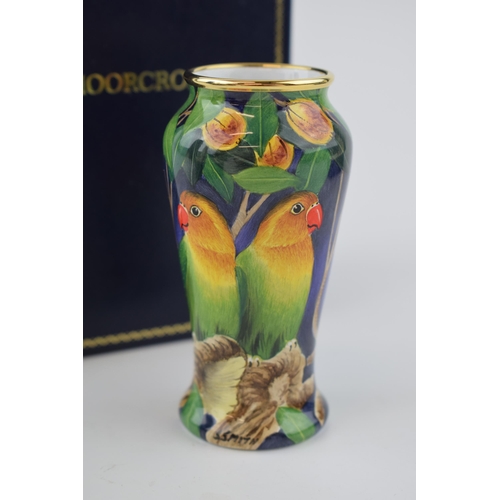 Boxed Moorcroft Enamel vase in the Lovebird pattern, 56/100, by Stephen Smith, 9cm tall.