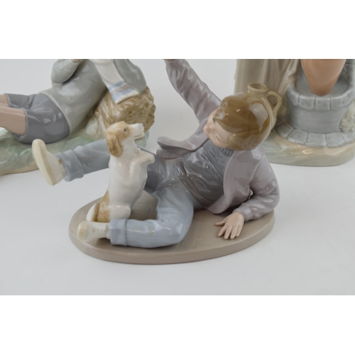 48 - A trio of figures to include a Lladro boy with a bird on his foot (bird glued back), with a pair of ... 