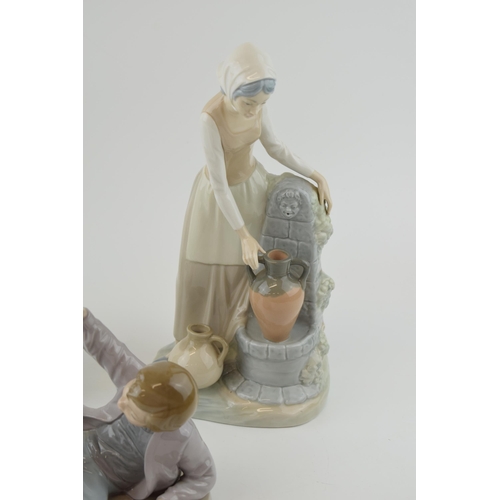 48 - A trio of figures to include a Lladro boy with a bird on his foot (bird glued back), with a pair of ... 