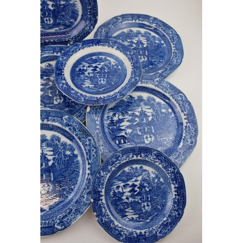 60 - A group of late 18th century pearlware blue and white transfer-printed “Two Figures” pattern dinner ... 