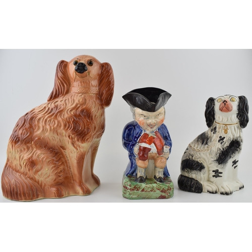 68 - A group of Victorian Staffordshire dog Figures, including a black and white spaniel, a brown spaniel... 