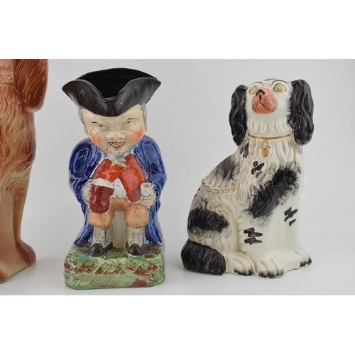 68 - A group of Victorian Staffordshire dog Figures, including a black and white spaniel, a brown spaniel... 