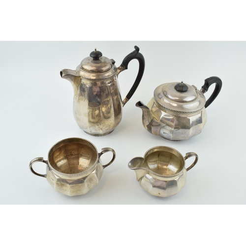 Hallmarked sterling silver tea set, Walker and Hall, Sheffield 1933, to include a teapot, a coffee pot, a milk jug and a two handled sugar bowl, ebonised handles and finials to the pots, combined gross weight 1716.8 grams / 55.2 oz (4).