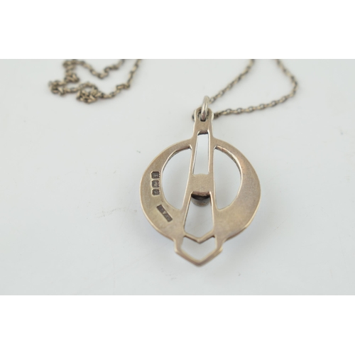 289 - Hallmarked silver enamelled pendant with central green paste stone with a white metal chain.