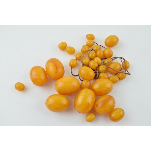 310 - Butterscotch amber or similar material graduated necklace beads. Weight 84 grams.