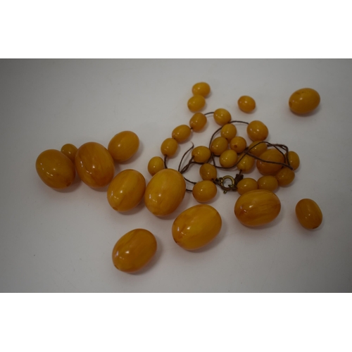 310 - Butterscotch amber or similar material graduated necklace beads. Weight 84 grams.