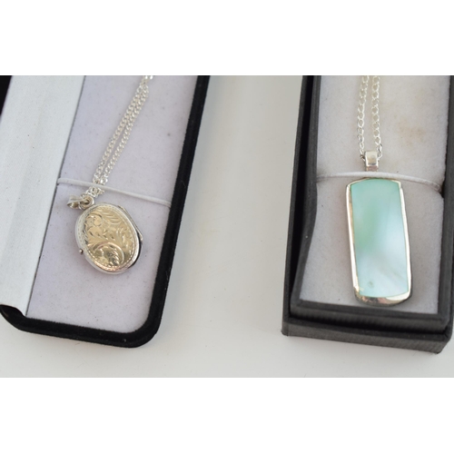 319 - A pair of contemporary sterling silver necklaces with pendants (2).